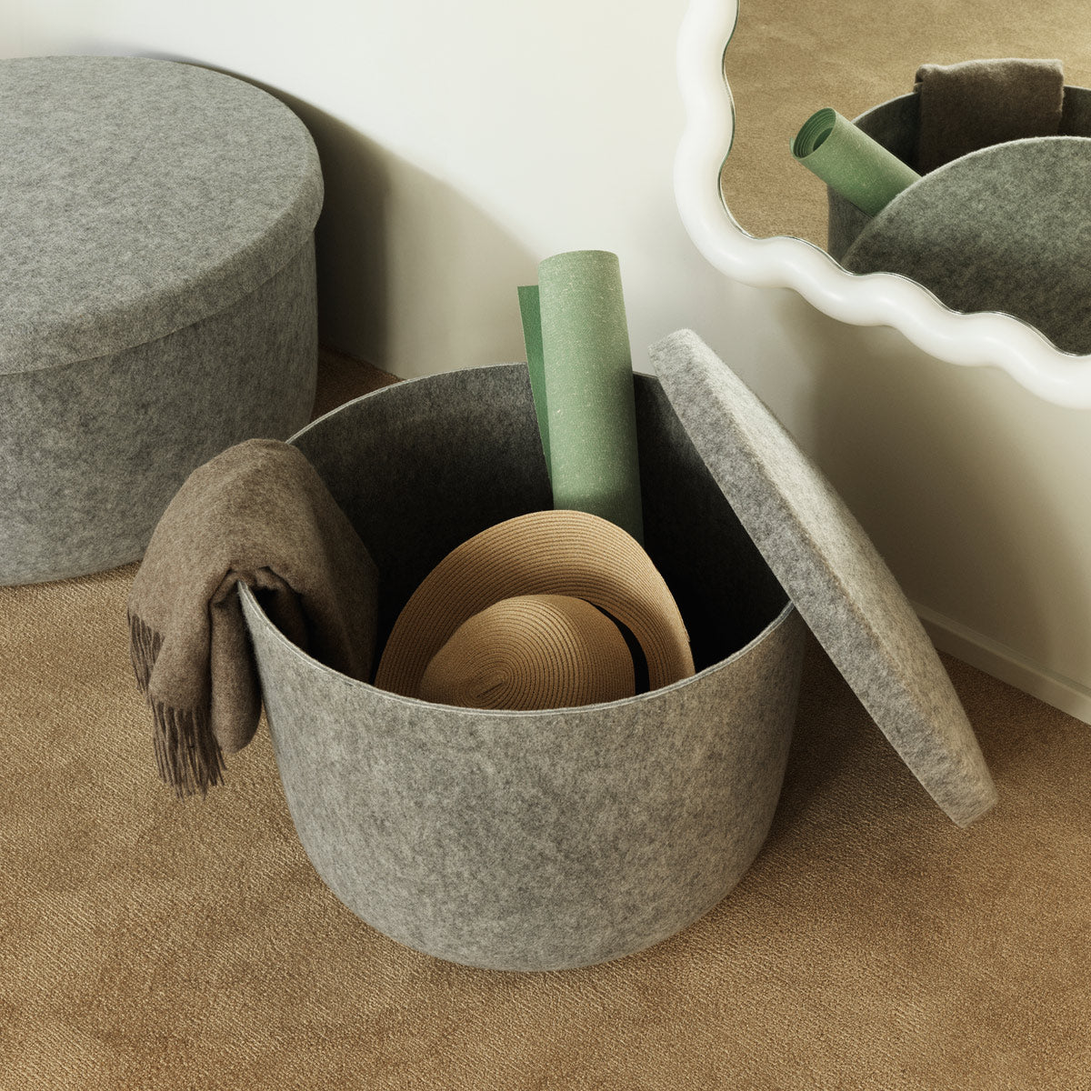 Hide Storage Pouf by Normann Copenhagen, showing hide storage poufs in live shot.