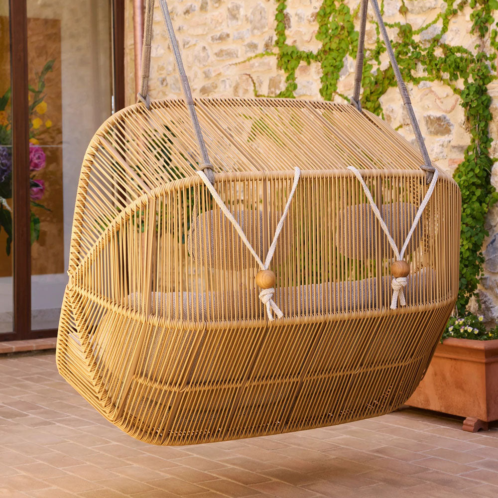 Hive 2-Seater Hanging Sofa With Rope by Cane-Line, showing hive 2-seater hanging sofa with rope in live shot.