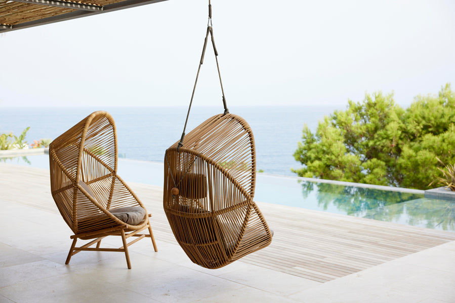 Hive Chair with Base by Cane-Line, showing hive chair with base in live shot.
