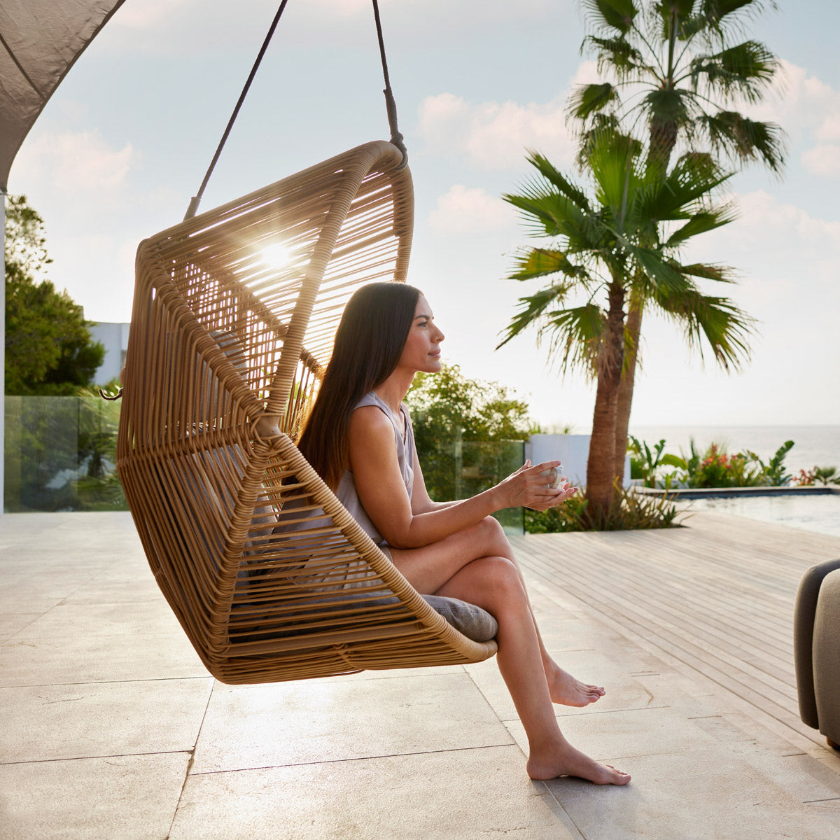 Hive Hanging Chair with Rope by Cane-Line, showing hive hanging chair with rope in live shot.