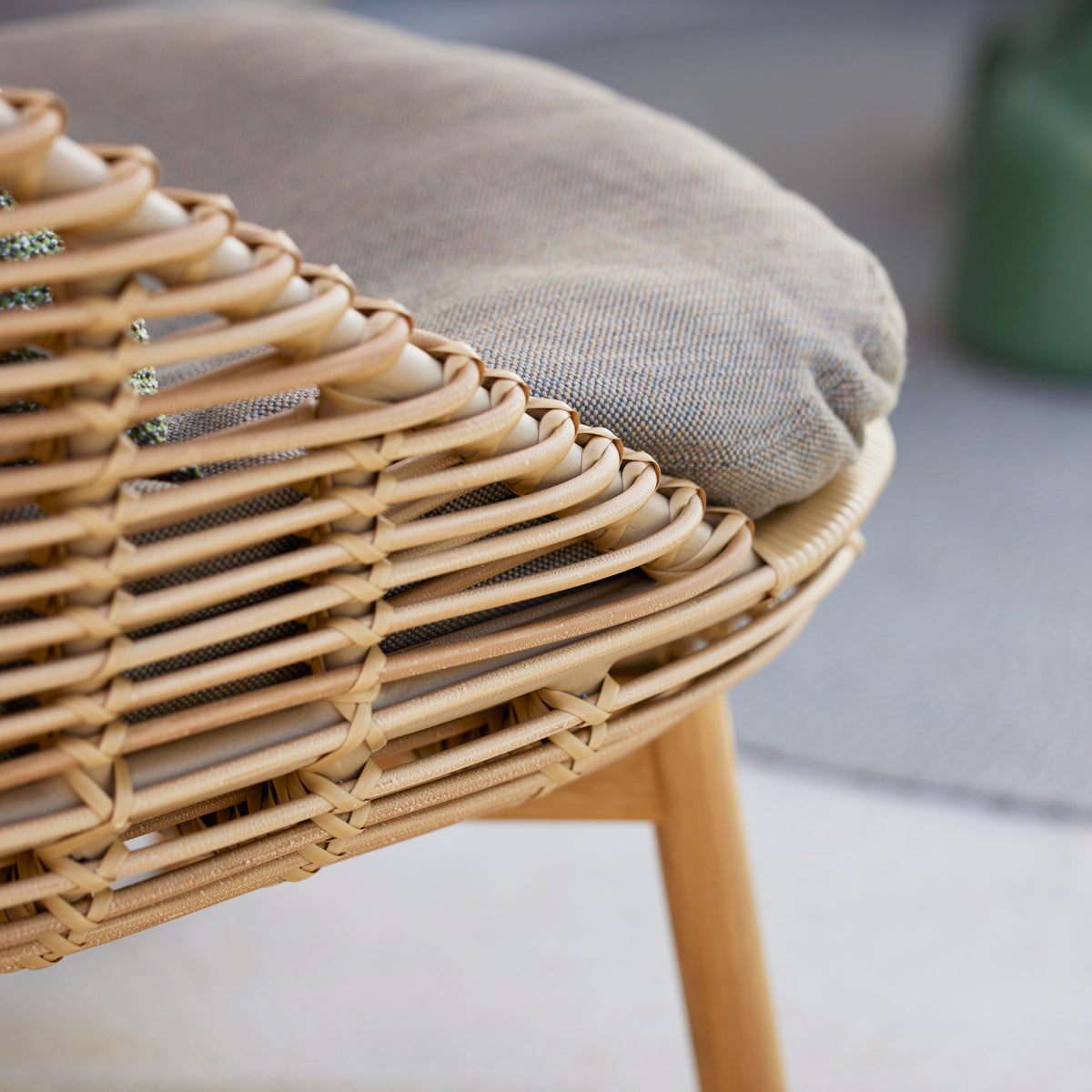 Hive Highback Chair by Cane-Line, showing closeup view of hive highback chair in live shot.