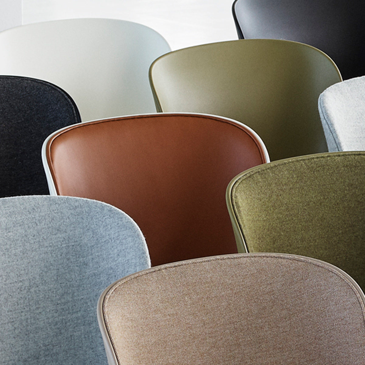 Hyg Front Upholstery Chair Wood Legs by Normann Copenhagen, showing closeup view of hyg front upholstery chair wood legs in live shot.