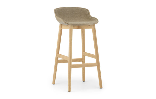 Hyg Front Upholstery High Wood Barstool by Normann Copenhagen - Sand Shell Seat & Lacquered Oak Legs, Group 2.