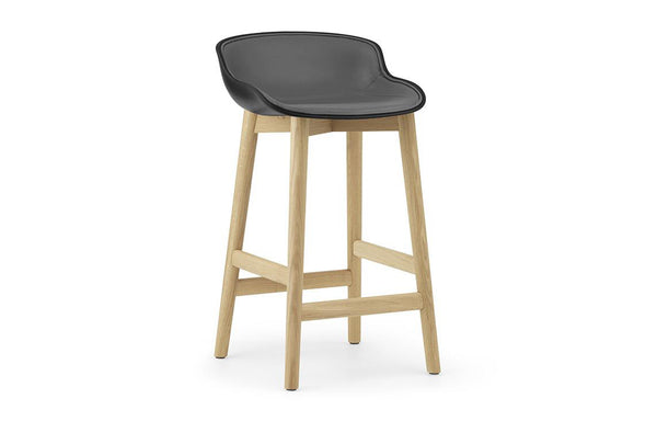 Hyg Front Upholstery Low Wood Barstool by Normann Copenhagen - Black Shell Seat & Lacquered Oak Legs, Group 7.