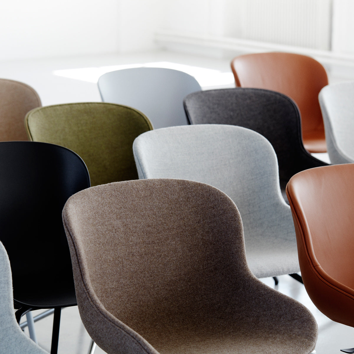 Hyg Full Upholstery Chair by Normann Copenhagen, showing closeup view of hyg full upholstery chairs in live shot.