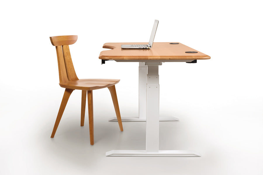 Invigo 26" x 72" Sit-Stand Desks Rounded Rectangle with Cutout/Wire Pass Grommet (Left) by Copeland Furniture, ,showing side view of invigo 26" x 72" sit-stand desks rounded rectangle with cutout/wire pass grommet (left) in natural cherry/white legs with chair.