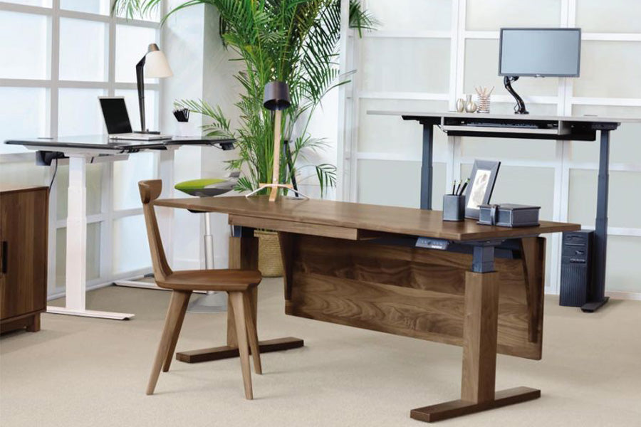 Invigo Large Sit-Stand Rectangle Desk with Cutout Wire Pass Grommet (Left) by Copeland Furniture, showing invigo large sit-stand rectangle desk with cutout wire pass grommet (left) in live shot.