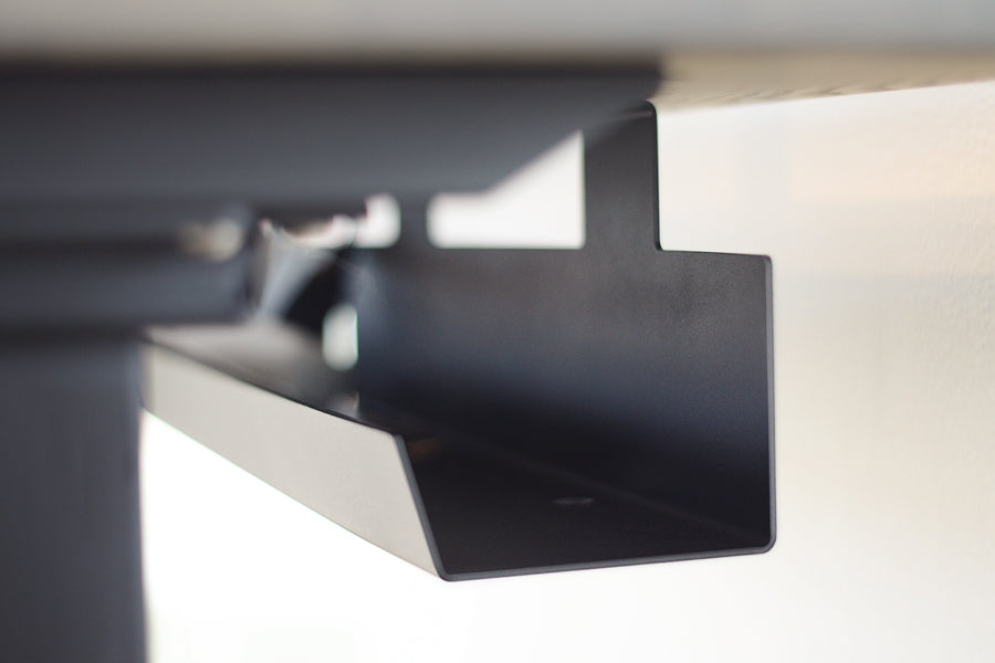 Invigo Large Sit-Stand Rounded Rectangle Desk with Wire Pass Grommet (Right) by Copeland Furniture, showing closeup view of invigo large sit-stand rounded rectangle desk with wire pass grommet (right) in live shot.