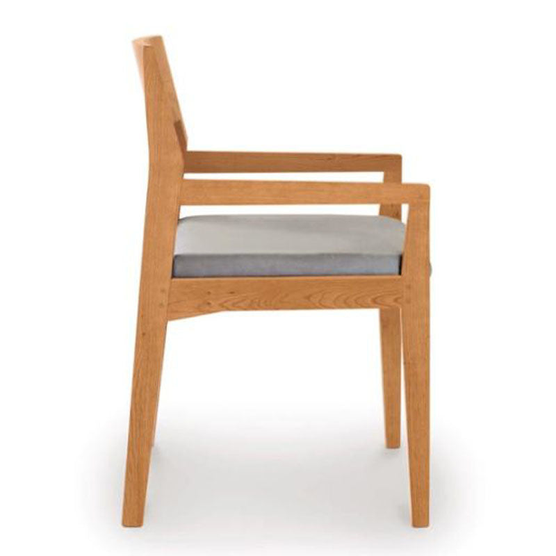 Iso ArmChair In Cherry by Copeland Furniture, showing side view of iso armchair In cherry.