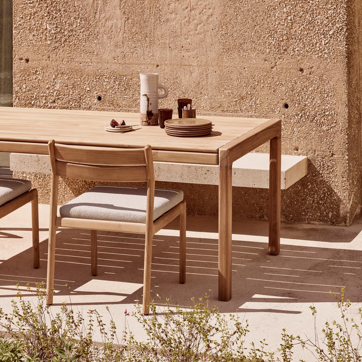 Jack Outdoor Dining Chair by Ethnicraft, showing closeup view of jack outdoor dining chairs in live shot.
