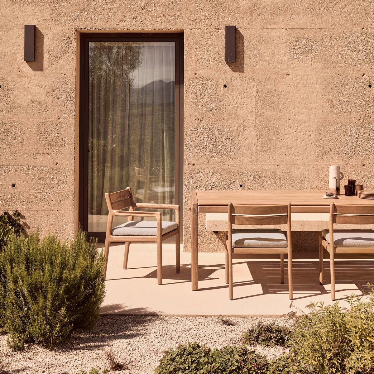 Jack Outdoor Dining Chair by Ethnicraft, showing jack outdoor dining chairs in live shot.