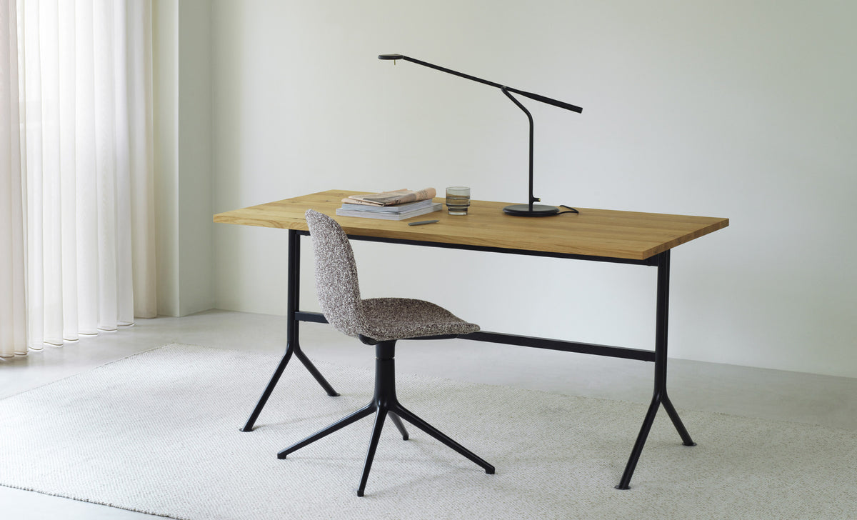 Kip Desk by Normann Copenhagen, showing kip desk with chair in live shot.