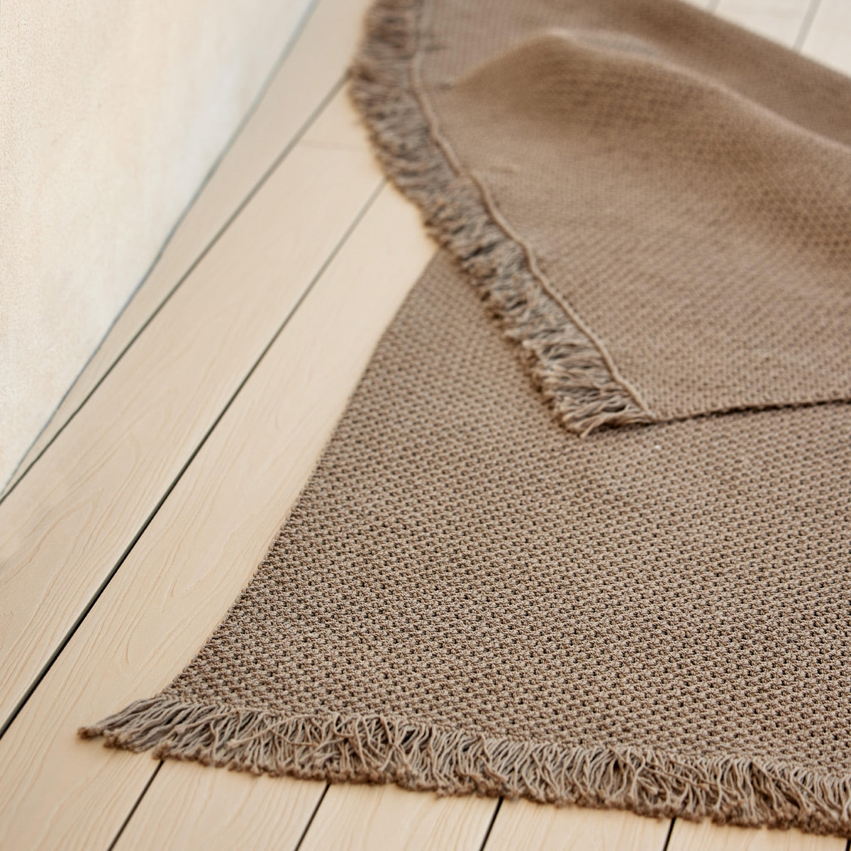 Knit Rug by Cane-Line, showing closeup view of knit rug in live shot.