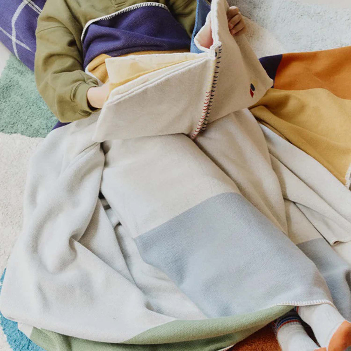 Knitted Color Composition Blanket by Lorena Canals, showing knitted color composition blanket in live shot.