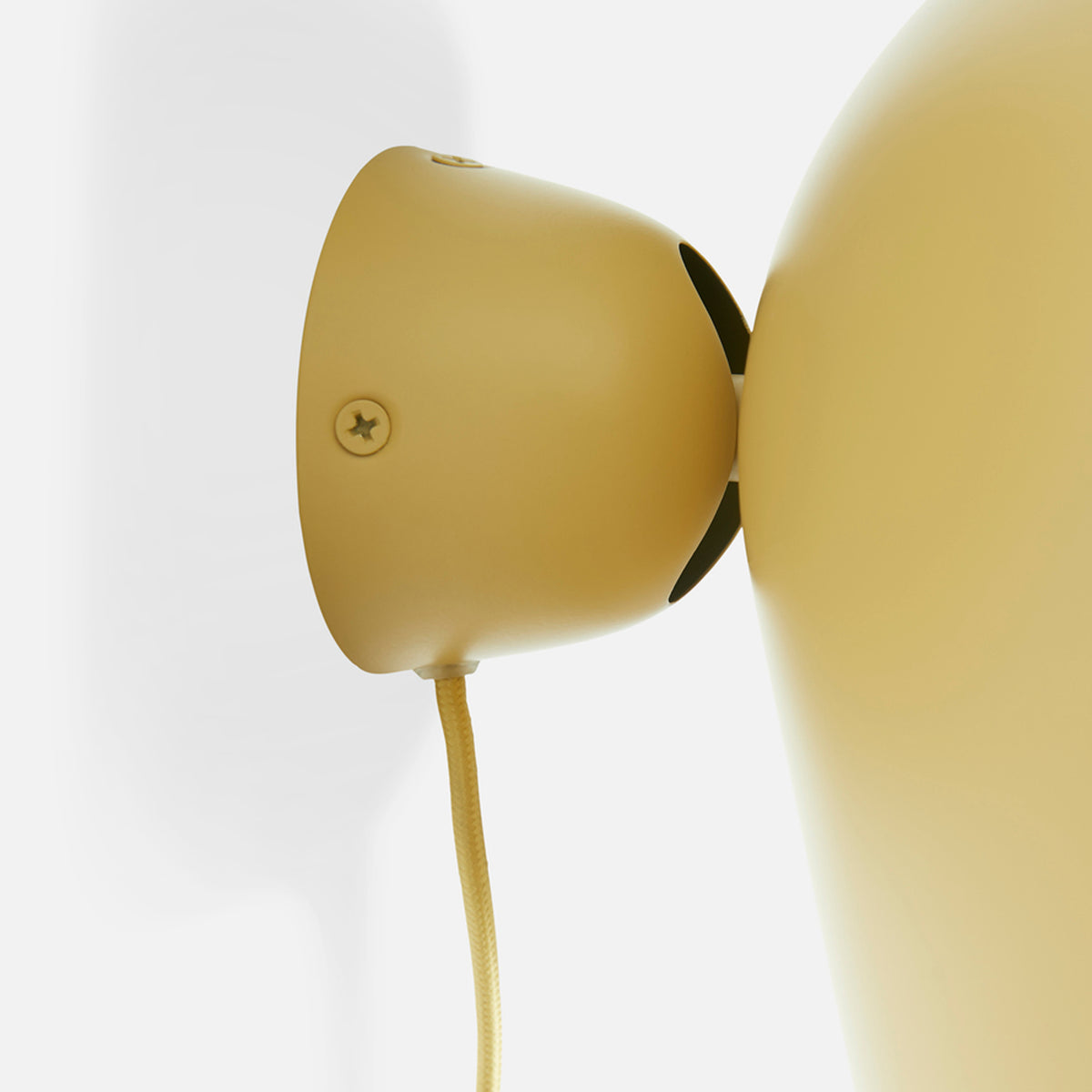 Kuppi Wall Lamp 2.0 by Woud, showing closeup view of kuppi wall lamp 2.0.