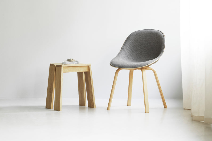 Let Stool by Normann Copenhagen, showing let stool with chair in live shot.