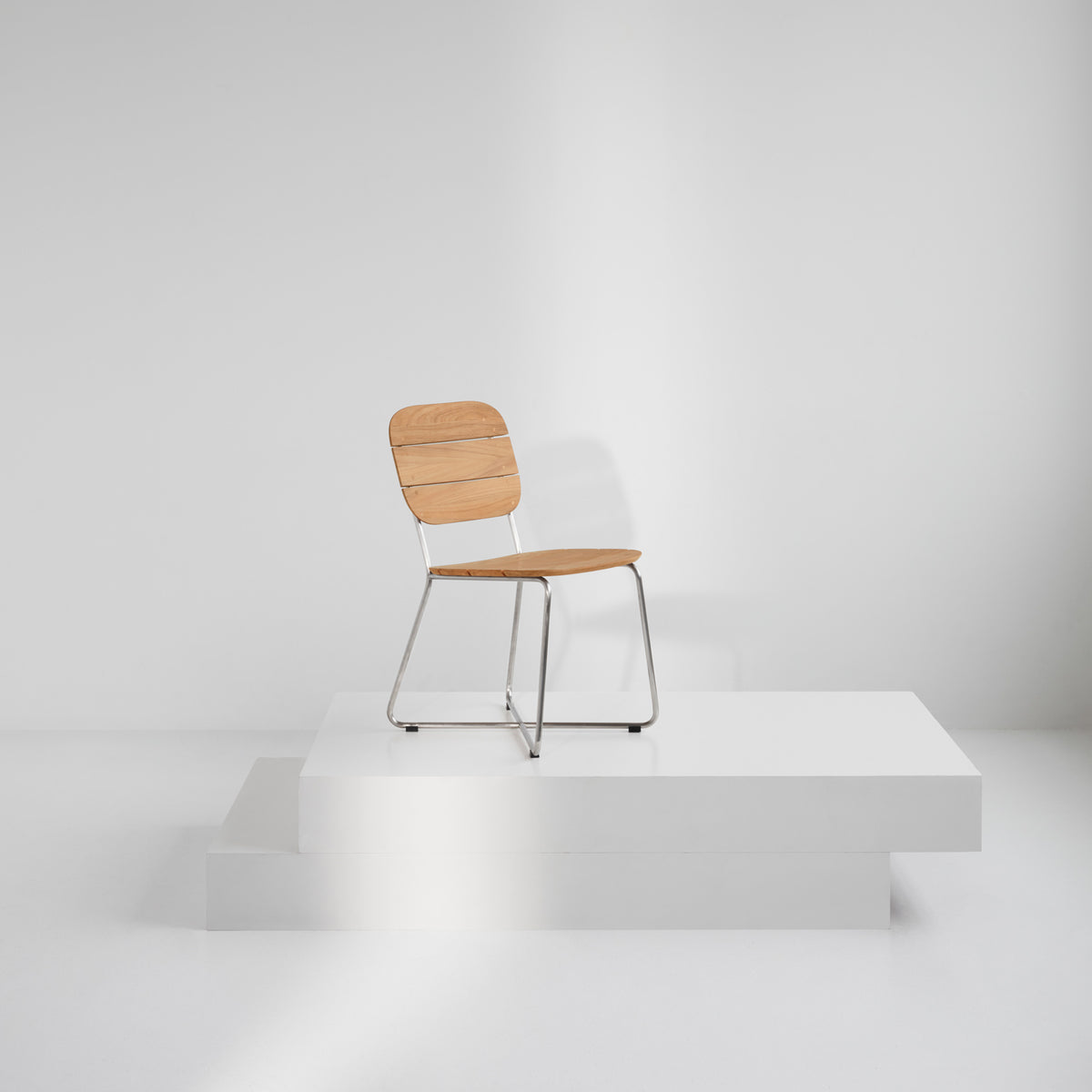 Lilium Teak Chair by Skagerak, showing lilium teak chair in live shot.