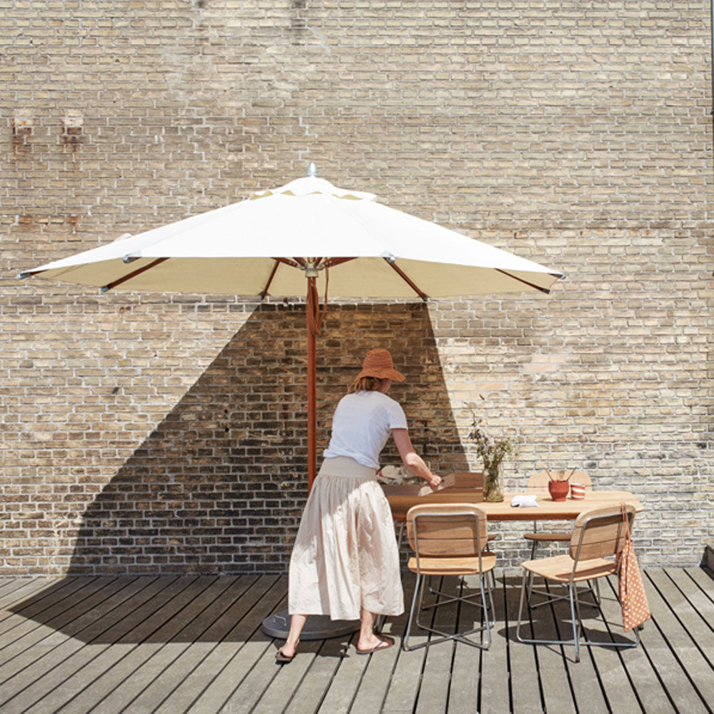 Lilium Teak Chair by Skagerak, showing lilium teak chair in live shot.
