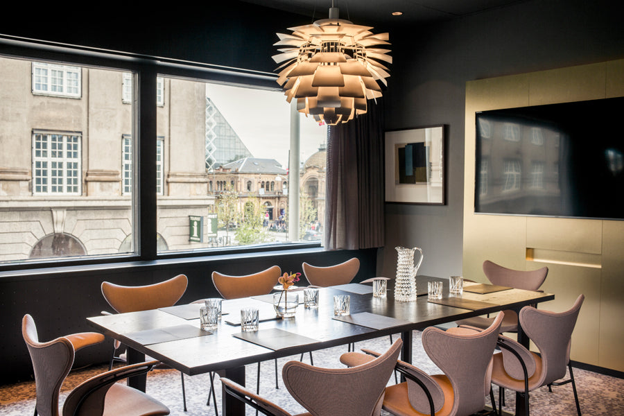 Lily Armchair by Fritz Hansen, showing lily armchairs in live shot.