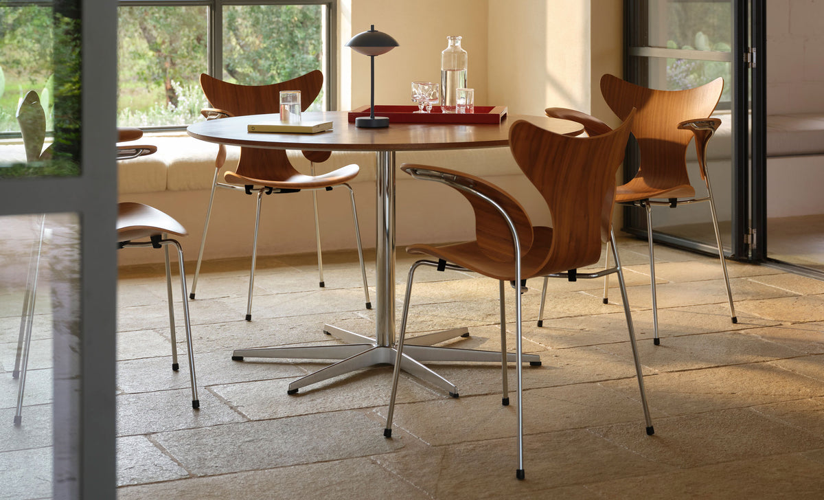Lily Armchair by Fritz Hansen, showing lily armchairs in live shot.