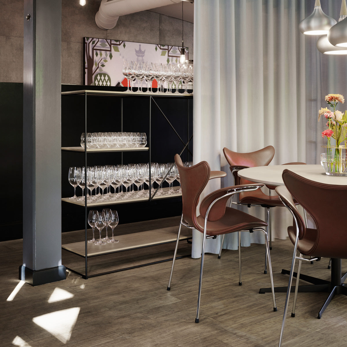 Lily Armchair by Fritz Hansen, showing lily armchairs in live shot.