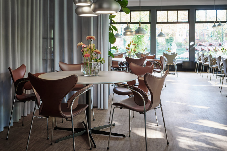 Lily Armchair by Fritz Hansen, showing lily armchairs in live shot.