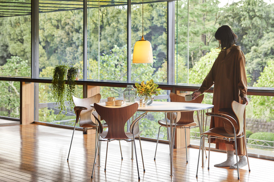 Lily Armchair by Fritz Hansen, showing lily armchairs in live shot.