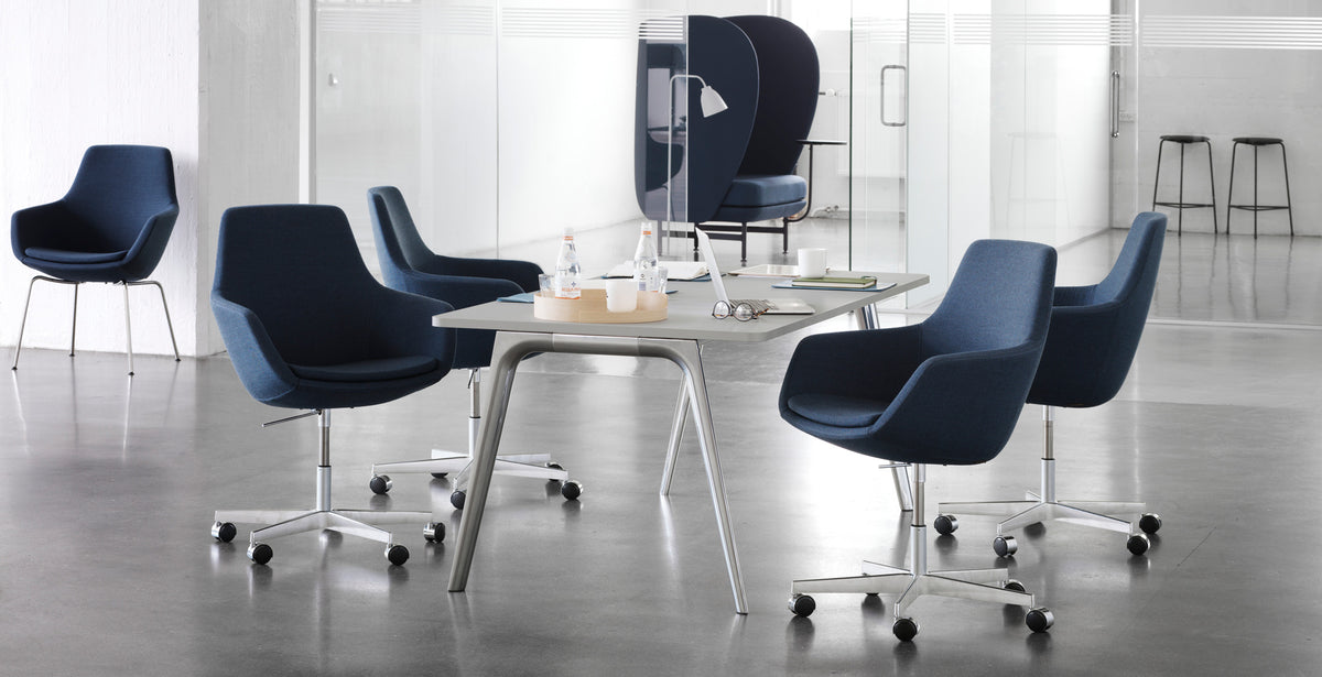 Little Giraffe Swivel Chair by Fritz Hansen, showing little giraffe swivel chairs in live shot.