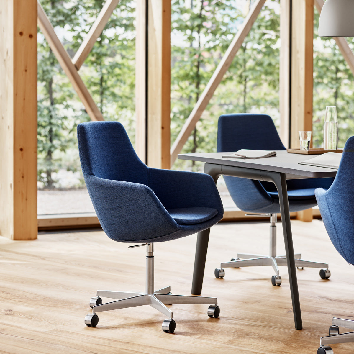 Little Giraffe Swivel Chair by Fritz Hansen, showing little giraffe swivel chairs in live shot.