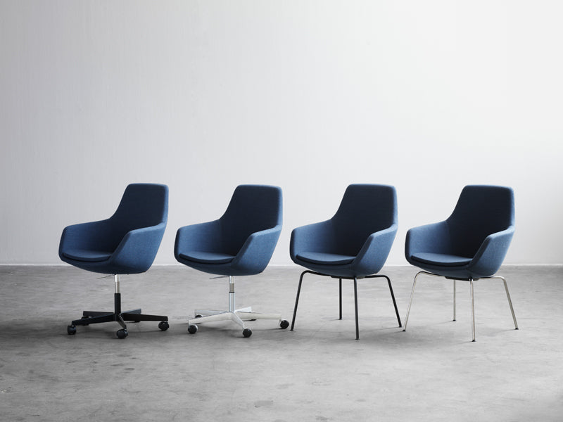 Little Giraffe Swivel Chair by Fritz Hansen, showing little giraffe swivel chairs in live shot.
