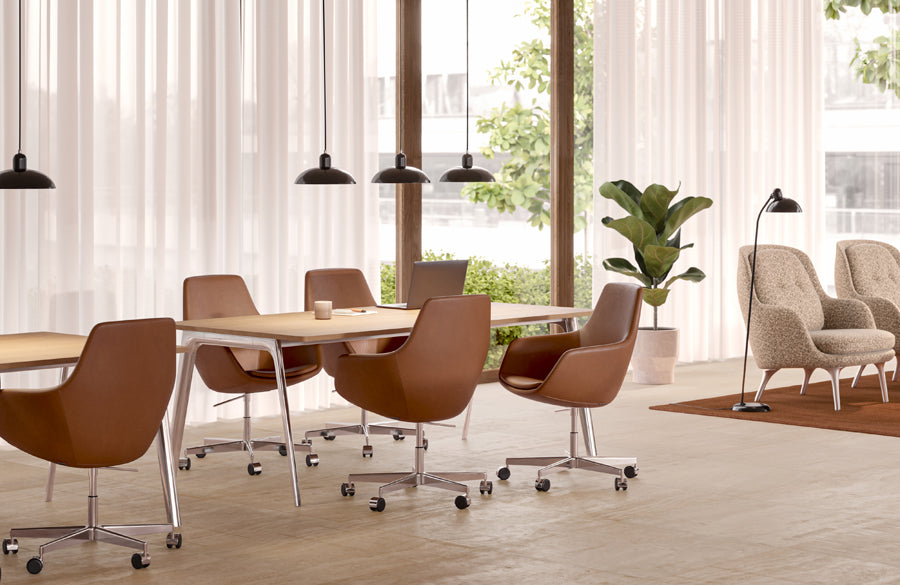 Little Giraffe Swivel Chair by Fritz Hansen, showing little giraffe swivel chairs in live shot.