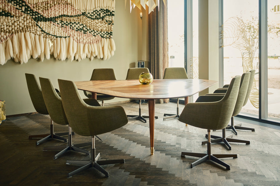 Little Giraffe Swivel Chair by Fritz Hansen, showing little giraffe swivel chairs in live shot.