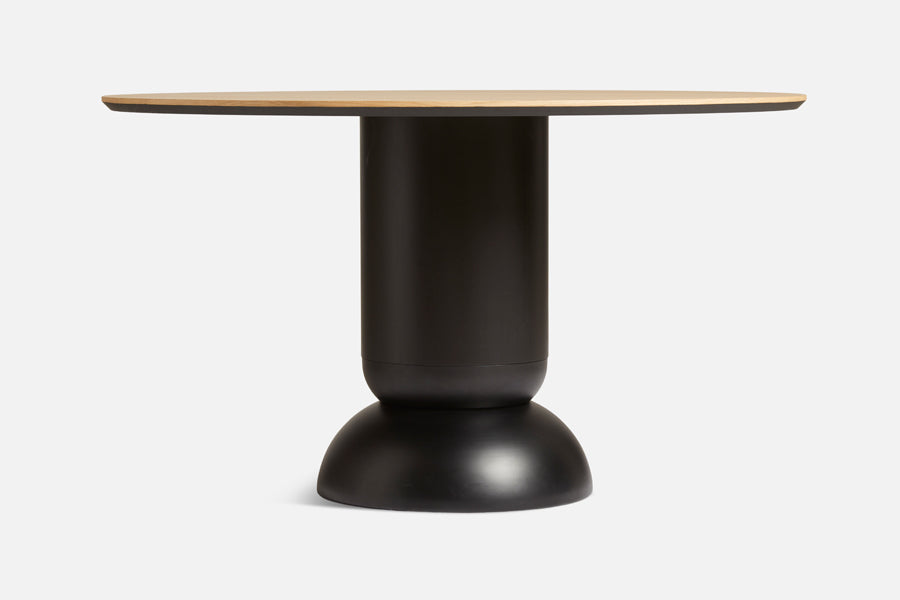 Ludo Dining Table by Woud, showing front view of ludo dining table in live shot.