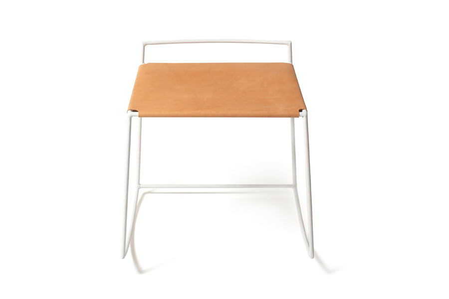Mia Rocking Stool by Tronk Design, showing front view of mia rocking stool in white powder coated steel/natural leather.