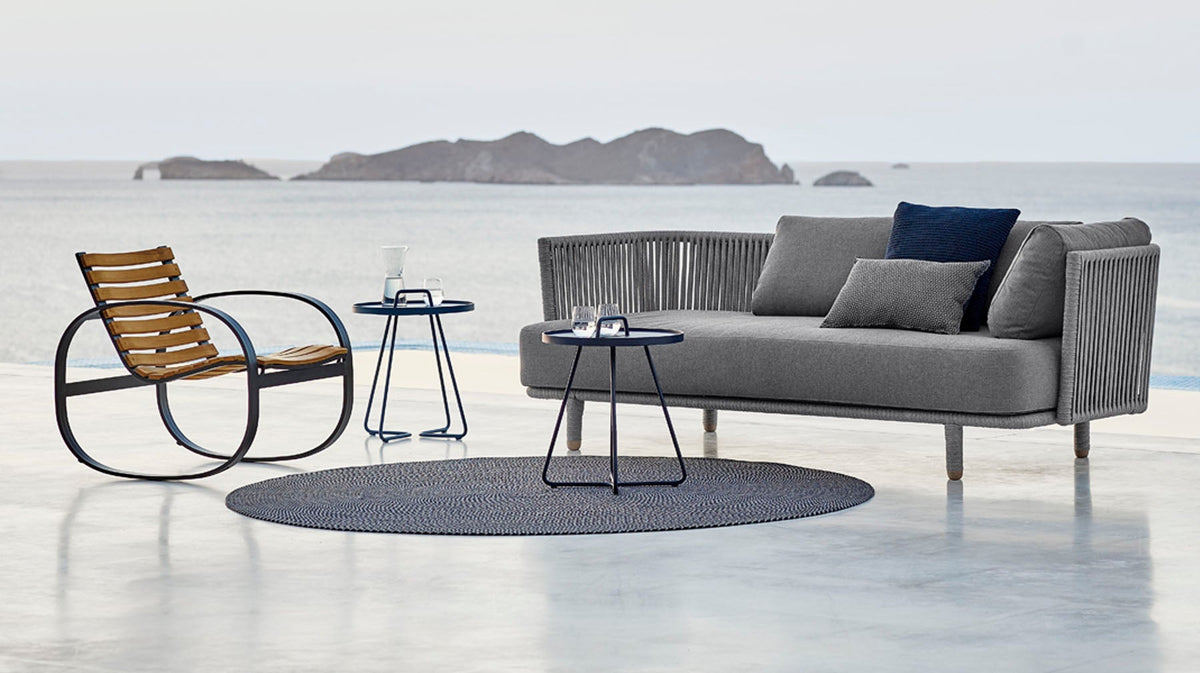 Moments Outdoor 3-Seater Sofa by Cane-Line, showing moments outdoor 3-seater sofa in live shot.