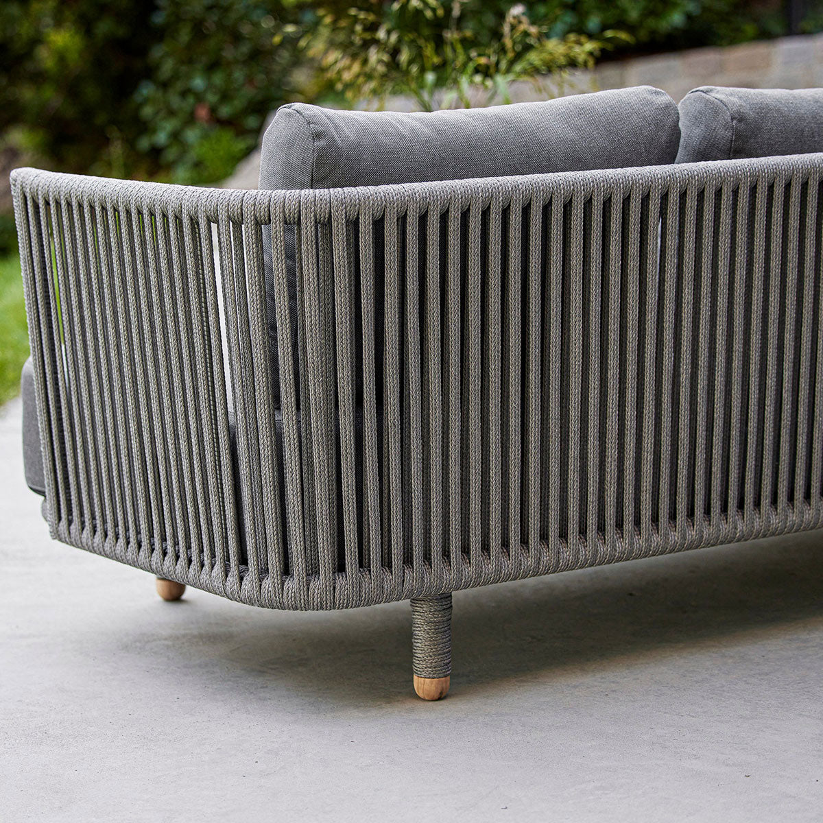 Moments Outdoor 3-Seater Sofa by Cane-Line, showing closeup view of moments outdoor 3-seater sofa in live shot.