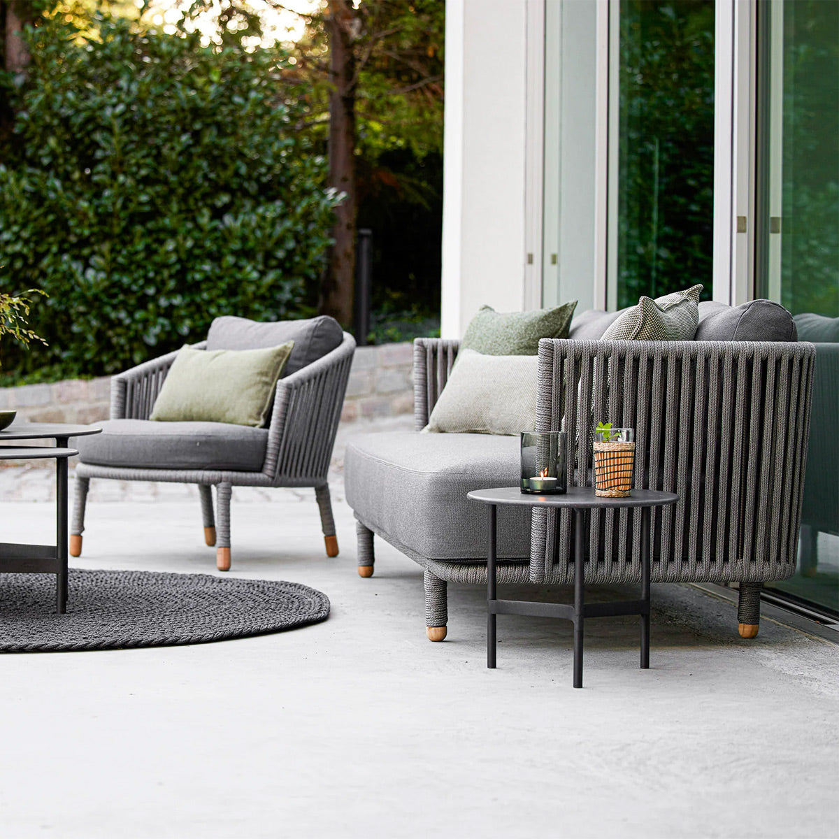 Moments Outdoor 3-Seater Sofa by Cane-Line, showing moments outdoor 3-seater sofa in live shot.