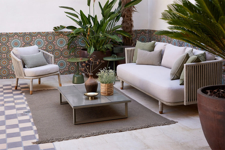 Moments Outdoor 3-Seater Sofa by Cane-Line, showing moments outdoor 3-seater sofa in live shot.