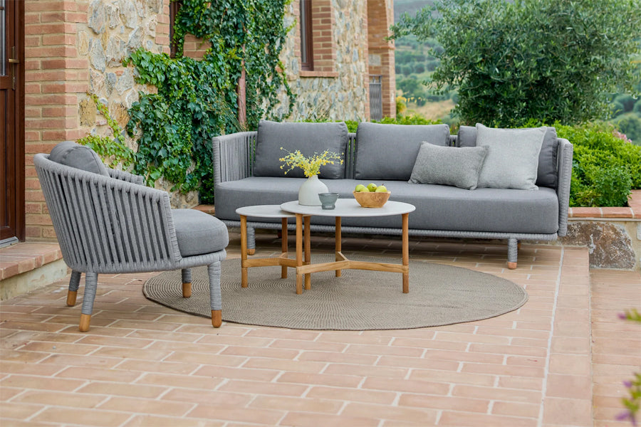Moments Outdoor 3-Seater Sofa by Cane-Line, showing moments outdoor 3-seater sofa in live shot.