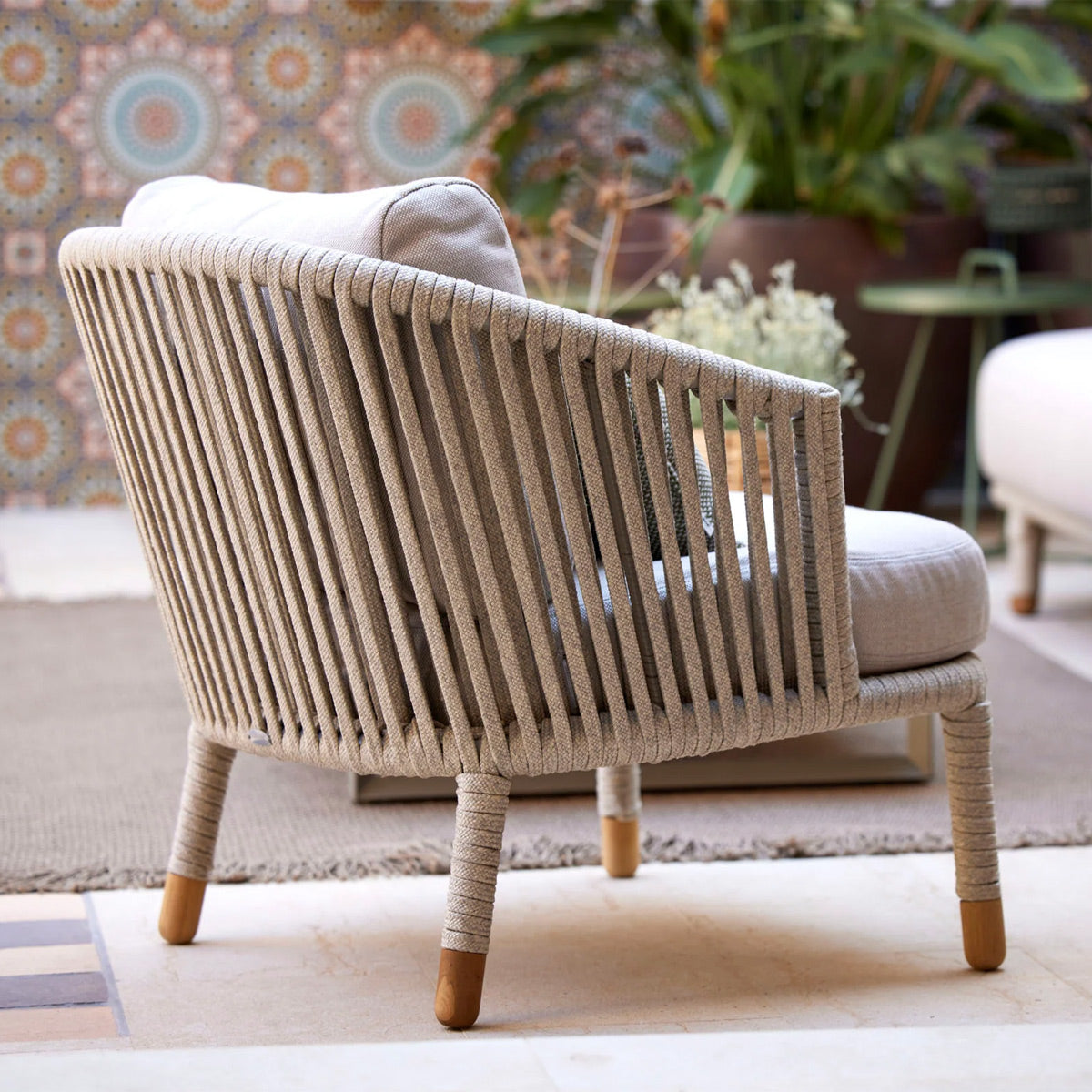 Moments Outdoor Lounge Chair by Cane-Line, showing moments outdoor lounge chair in live shot.