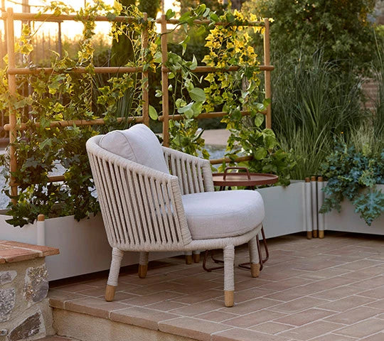 Moments Outdoor Lounge Chair by Cane-Line, showing moments outdoor lounge chair in live shot.