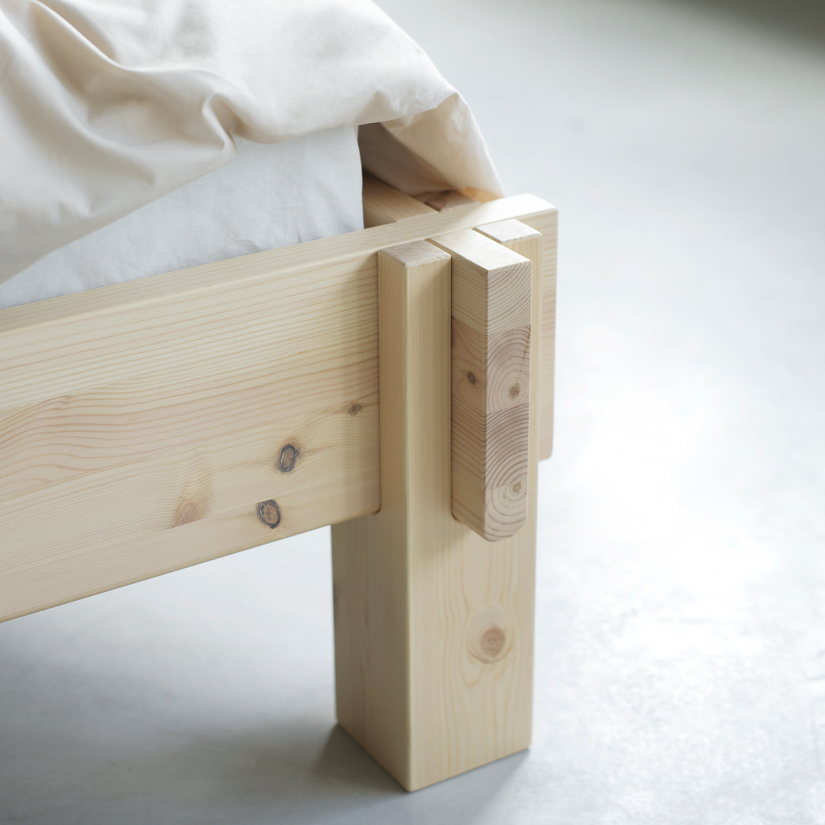Notch Bed Frame by Normann Copenhagen, showing closeup view of notch bed frame in live shot.
