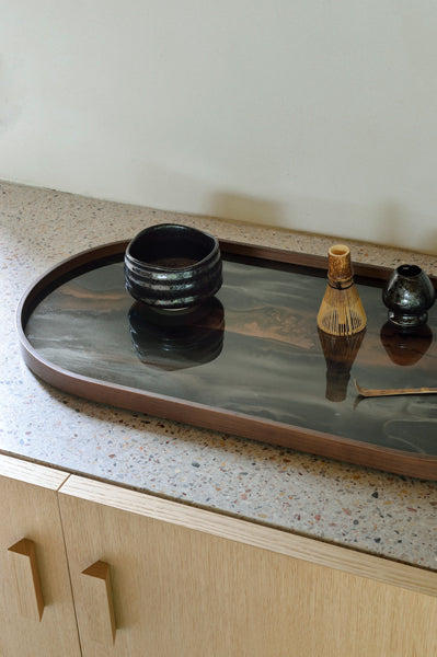 Organic Glass Tray by Ethnicraft, showing closeup view of organic glass tray in live shot.