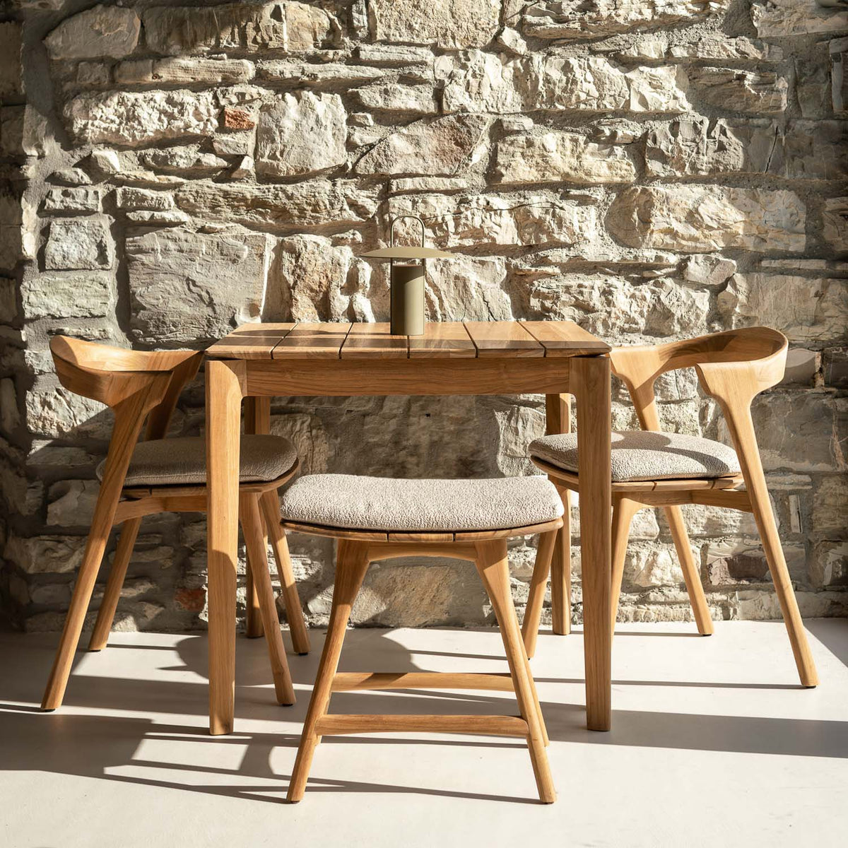 Osso Outdoor Stool by Ethnicraft, showing osso outdoor stool in live shot.