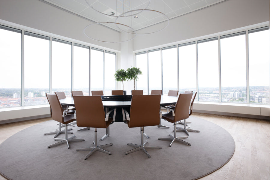 Oxford 5-Star Base Armchair by Fritz Hansen, showing oxford 5-star base armchairs in live shot.
