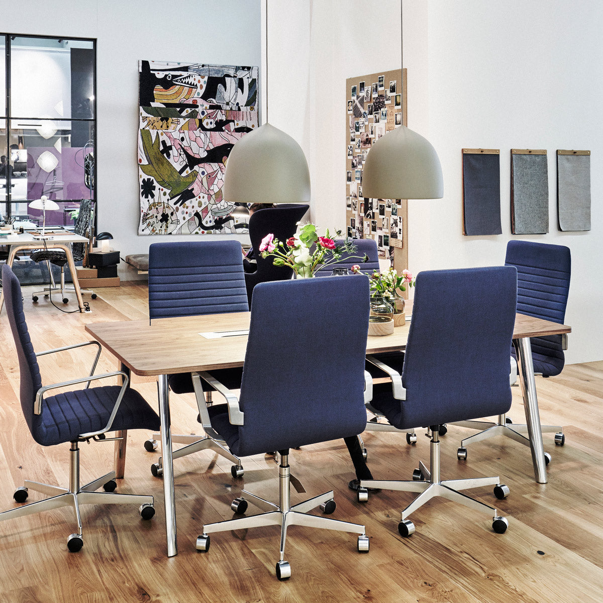 Oxford 5-Star Base Armchair with Castors by Fritz Hansen, showing oxford 5-star base armchairs with castors in live shot.