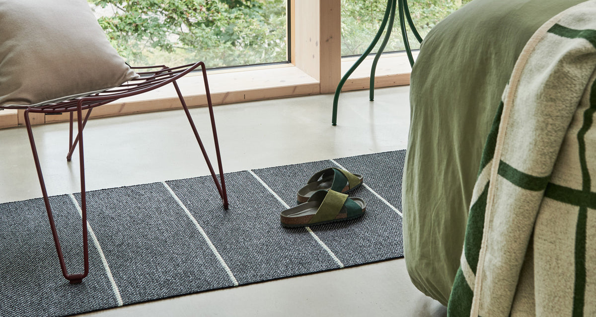 Lea Black Runner Rug by Pappelina, showing lea black runner rug in live shot.