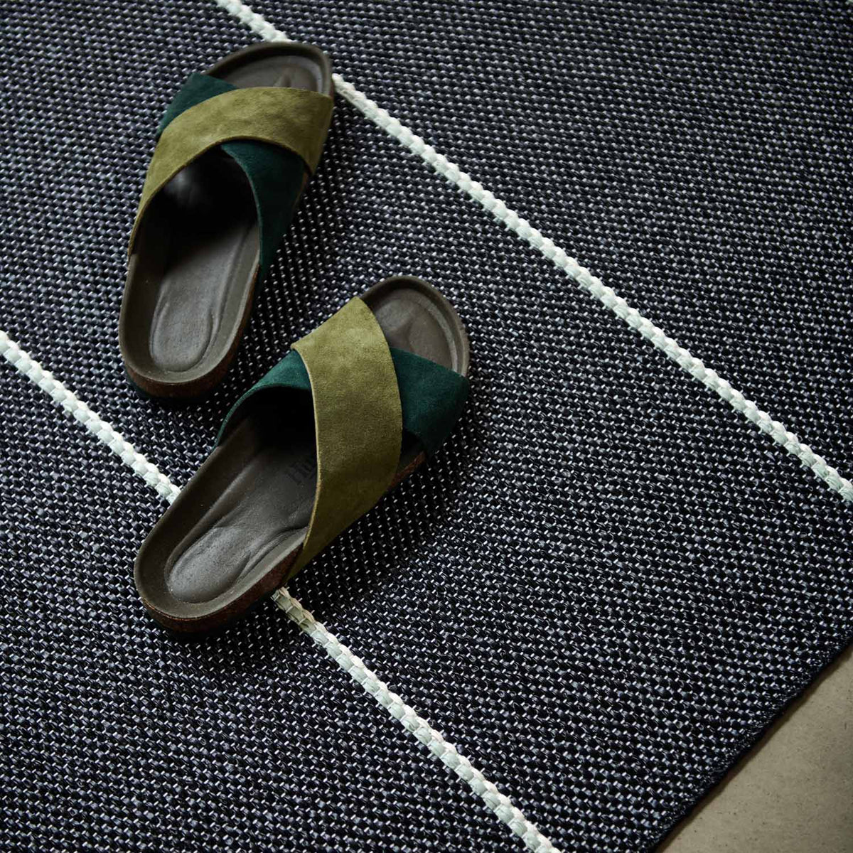 Lea Black Runner Rug by Pappelina, showing lea black runner rug in live shot.