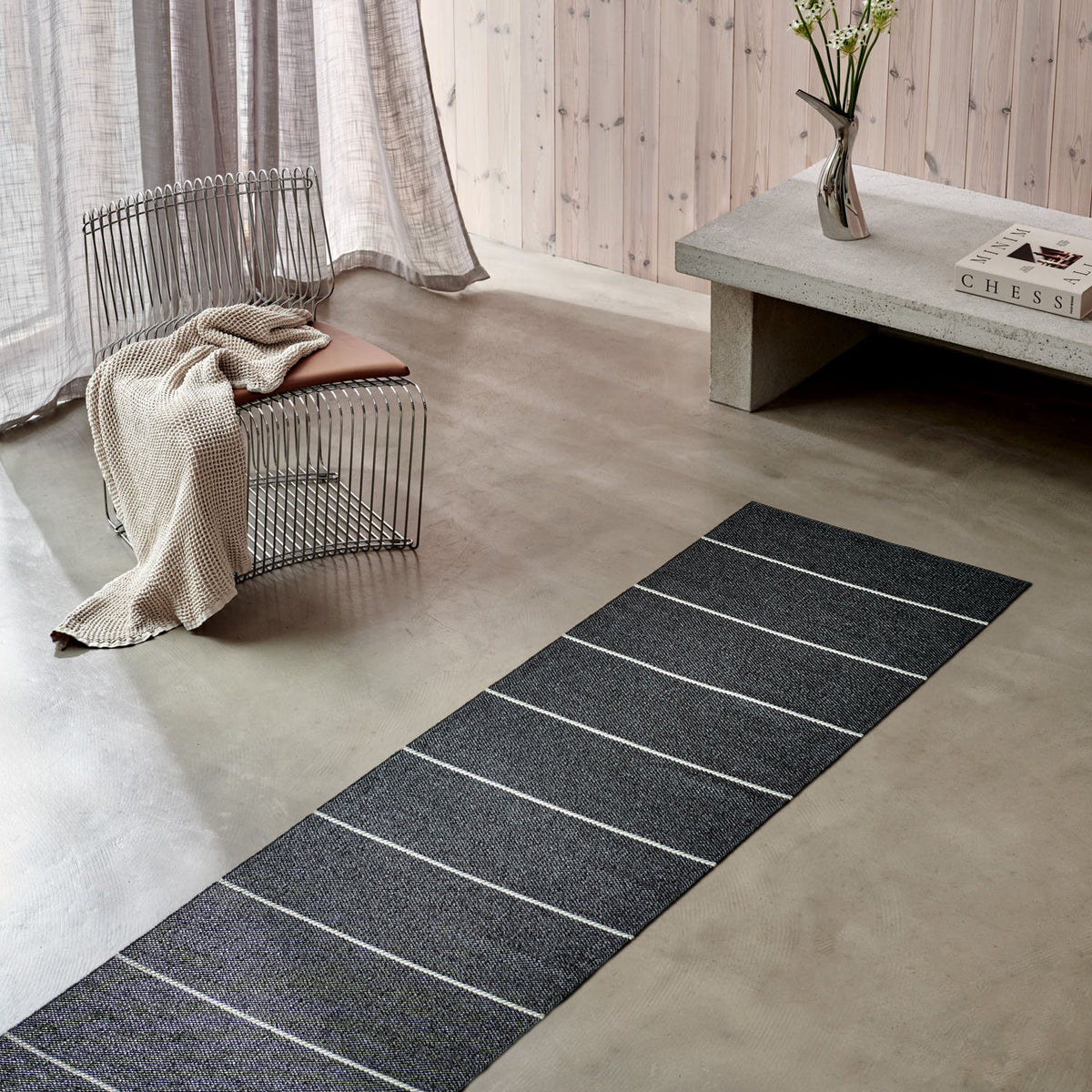 Lea Black Runner Rug by Pappelina, showing lea black runner rug in live shot.