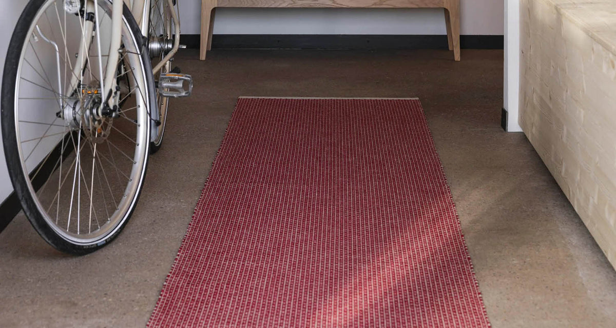 NILS Dark Red Runner Rug by Pappelina, showing nils dark red runner rug in live shot.
